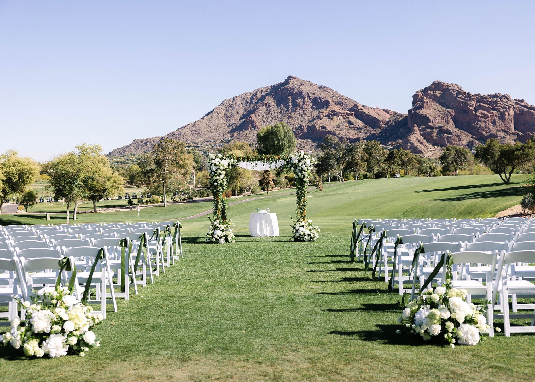 Elegant outdoor wedding ceremony in Scottsdale Arizona with wedding party celebrating