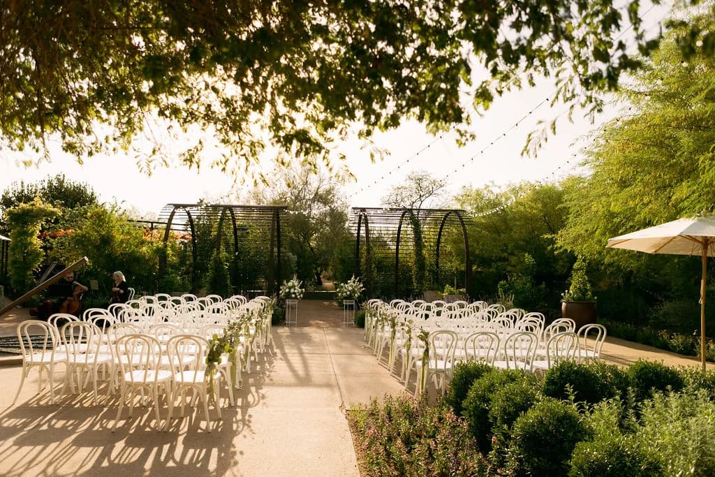 Desert Botanical Garden wedding ceremony among garden arbors at golden hour