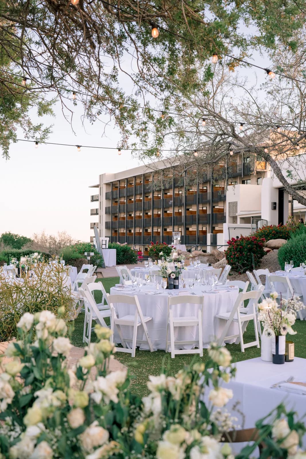 Outdoor reception tables with white florals at Adero Scottsdale Resort