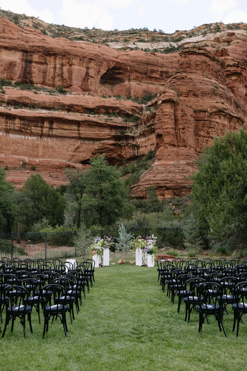 Enchantment Resort wedding ceremony aisle beneath Sedona red rock cliffs