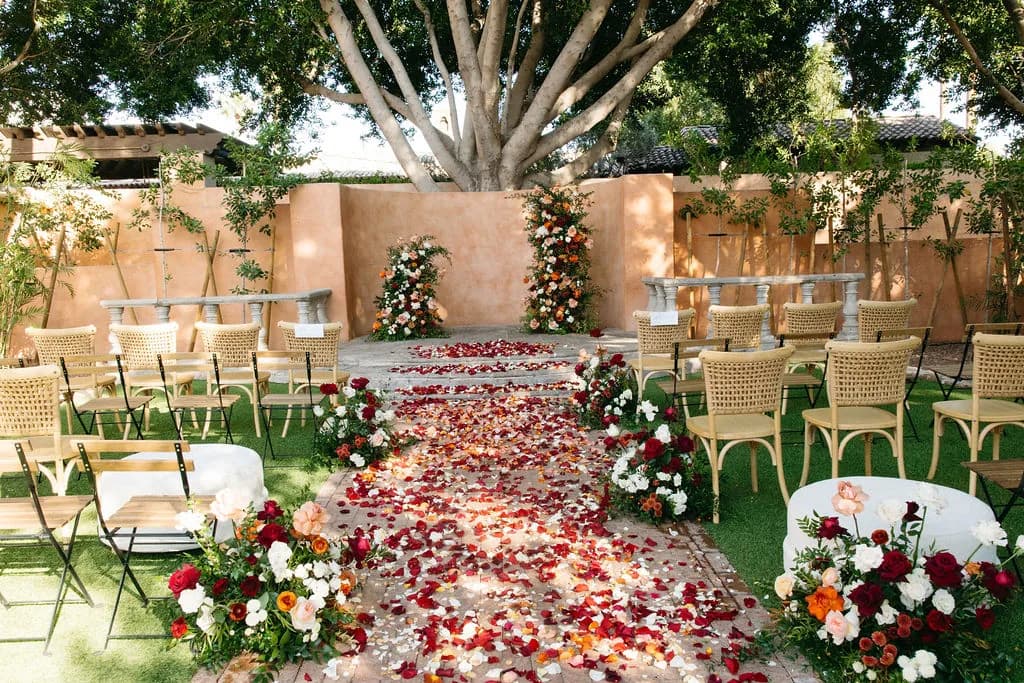 Petal-lined wedding aisle beneath a canopy tree at Royal Palms Resort