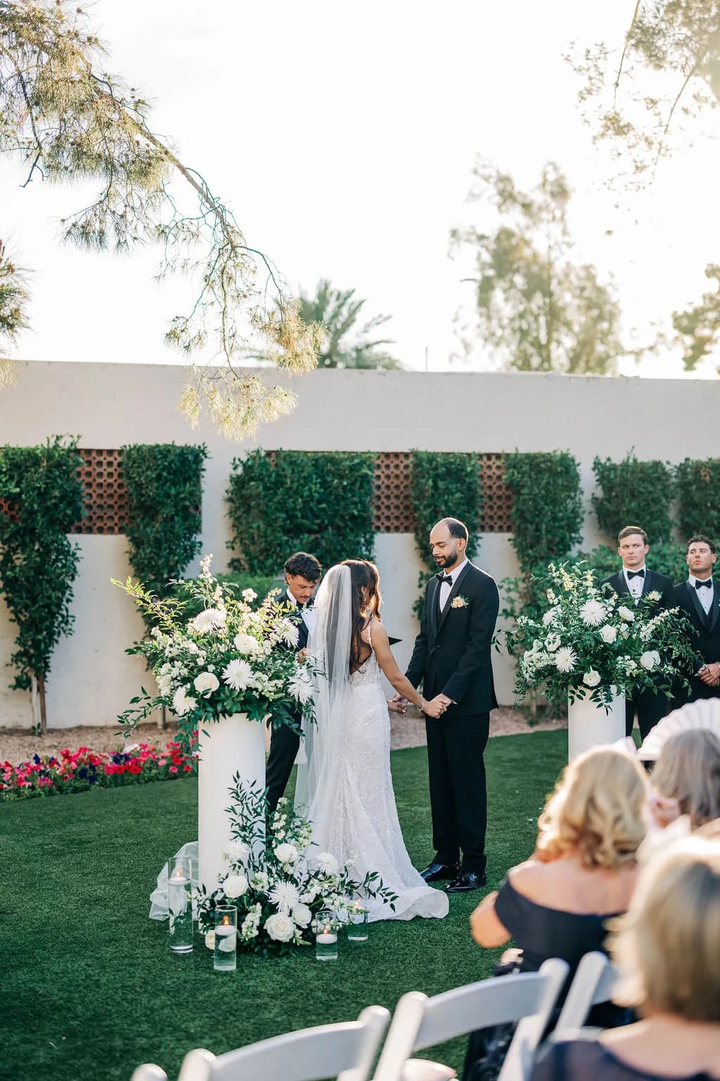 Wedding ceremony altar against a greenery wall at The Scottsdale Resort